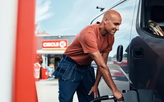 Man happily fueling his van