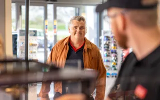 Man smiling entering Circle K store