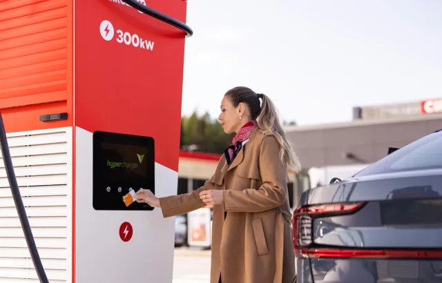 Woman tapping her card to pay for electric charging of her car